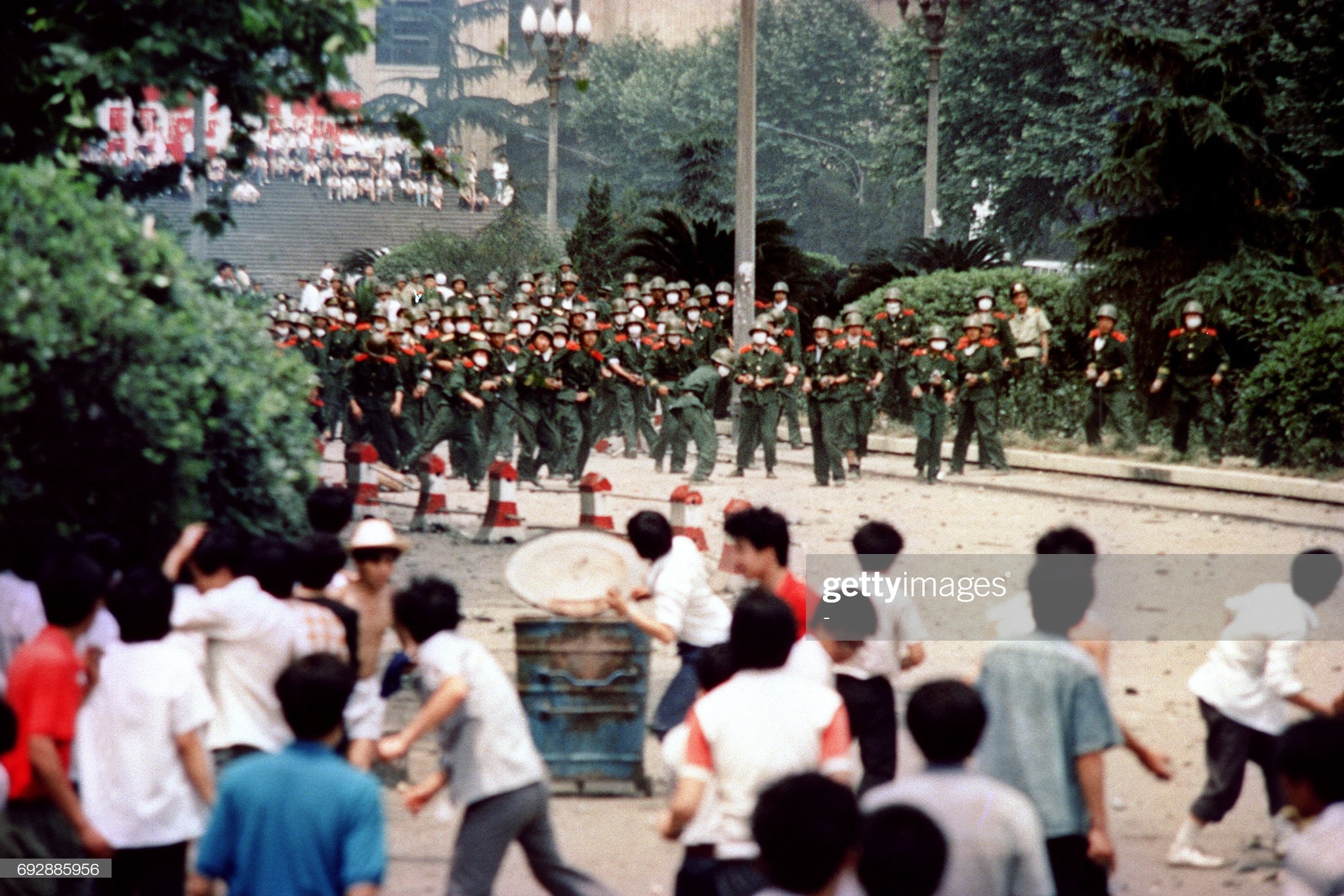 Chinese citizens and students of Chengdu capital of Sichuan province hurl stones at troop on June 4 1989 during a rioting following the proclamation of the martial in the city A series of pro-democracy protests was sparked by the April 15 death of former communist party leader Hu Yaobang In a show of force China leaders vented their fury and frustration on student dissidents and their pro-democracy supporters Several hundred people have been killed and thousands wounded when soldiers moved on Tiananmen Square during a violent military crackdown ending six weeks of student demonstrations known as the Beijing Spring movement According to Amnesty International five years after the crushing of the Chinese pro-democracy movement thousands of prisoners remained in jail AFP PHOTO STAFF Photo by - AFP Photo credit should read -AFPGetty Images