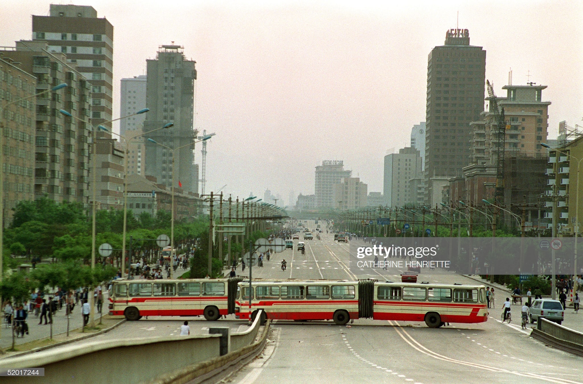 BEIJING CHINA - MAY 21 Two city buses block the main street to Tiananmen Square Jianguomen Avenue 21 May 1989 to keep the military forces out after the Martial Law was proclaimed in Beijing 20 May In a show of force 04 June China leaders vented their fury and frustration on student dissidents and their pro-democracy supporters Several hundred people have been killed and thousands wounded when soldiers moved on Tiananmen Square during a violent military crackdown ending six weeks of student demonstrations Photo credit should read CATHERINE HENRIETTEAFPGetty Images